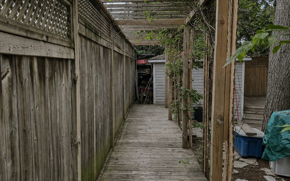 Weathered grey cedar deck before restoration