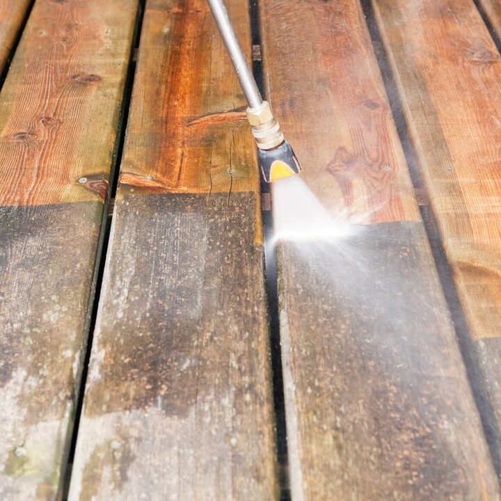 Controlled pressure washing revealing restored wood grain