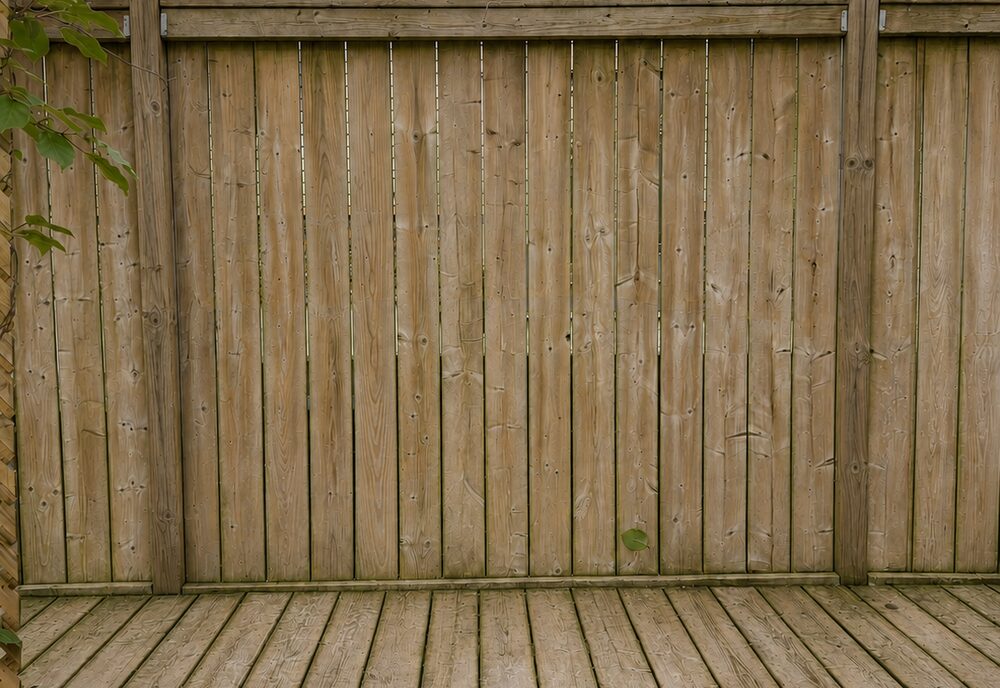Deck after DIY pressure washing — streaked and still grey